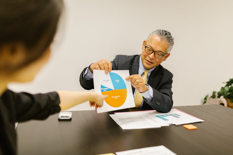Professional setting with colleagues discussing charts during a business meeting.